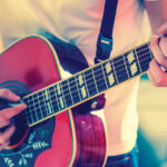 closeup on hands playing guitar